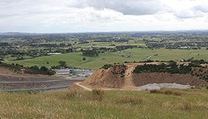 The view west from the bund on top of Drury Quarry. The ridge that is being stripped in preparation for extraction can be seen to the left. In the background between the quarry and the Southern Motorway is the site for the Drury South project – a new 223 hectare industrial zone, designed to accommodate construction, manufacturing, wholesale trade and distribution activities.