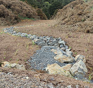 Stone water courses for diverting rainwater from the new fill to a flock station.